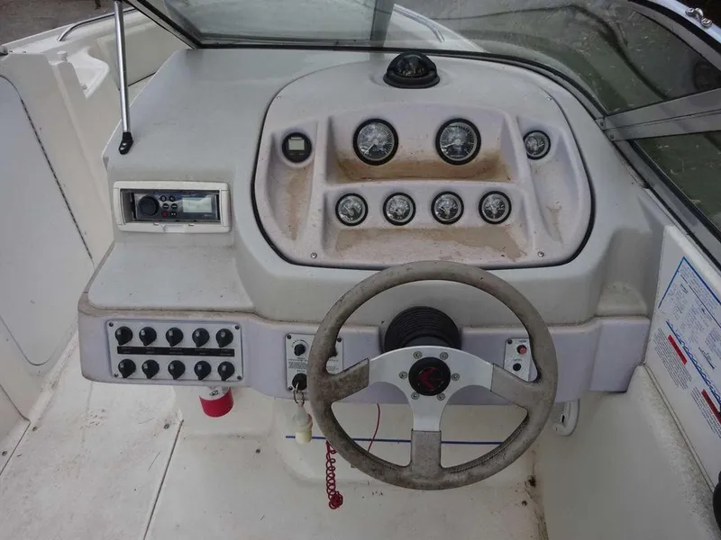 Slide: The Image of 1996 Wellcraft 2400S ECLIPSE boat dashboard with steering wheel and control panel. - 13