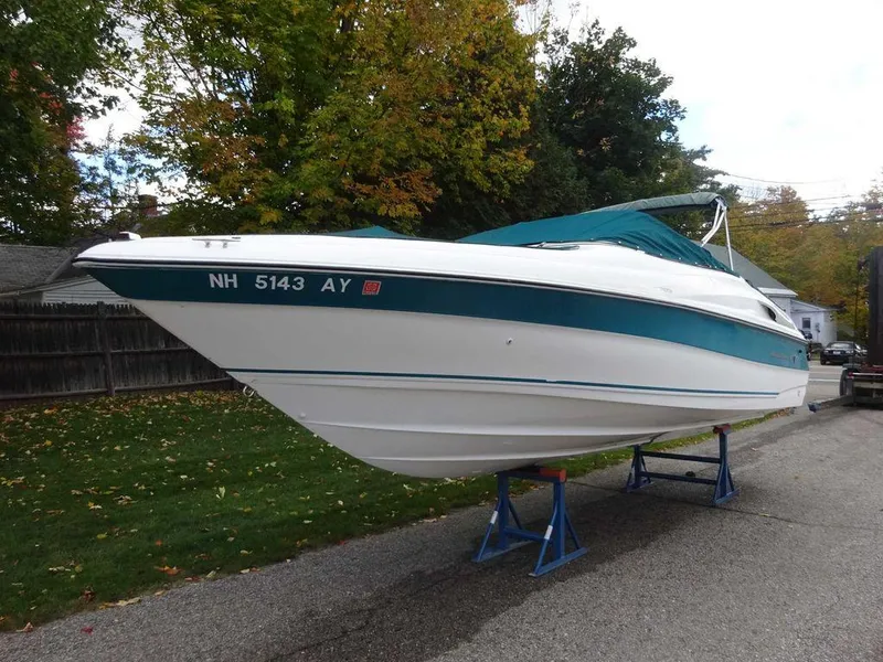 Slide: The Image of 1996 Wellcraft 2400S ECLIPSE boat on stands, white with teal accents. - 3