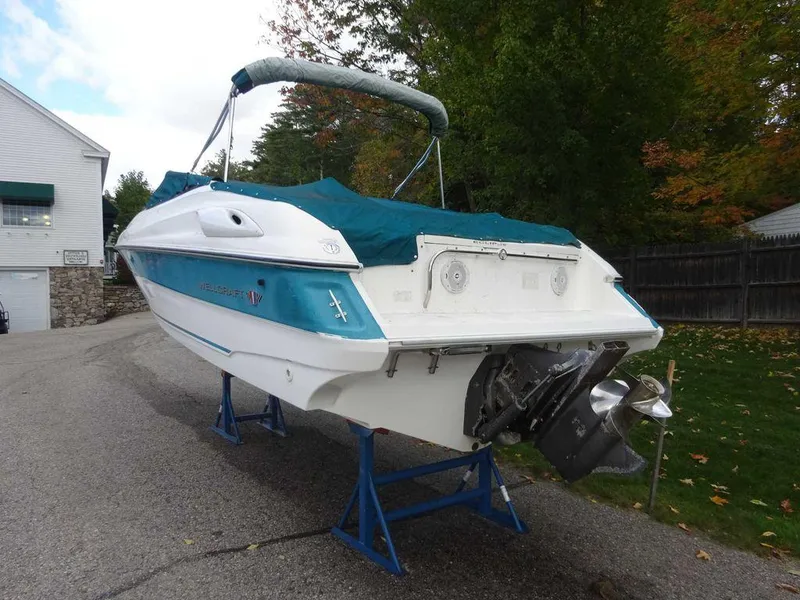 Slide: The Image of 1996 Wellcraft 2400S ECLIPSE boat on stands, covered and parked outdoors. - 4