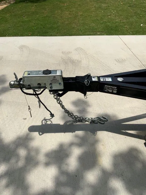 Slide: The Image of Trailer hitch of a 2012 Sea Ray 205 Sport on concrete driveway. - 11