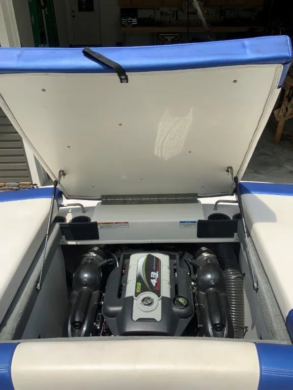 Slide: The Image of Open engine compartment of 2012 Sea Ray 205 Sport boat, showcasing engine details. - 6