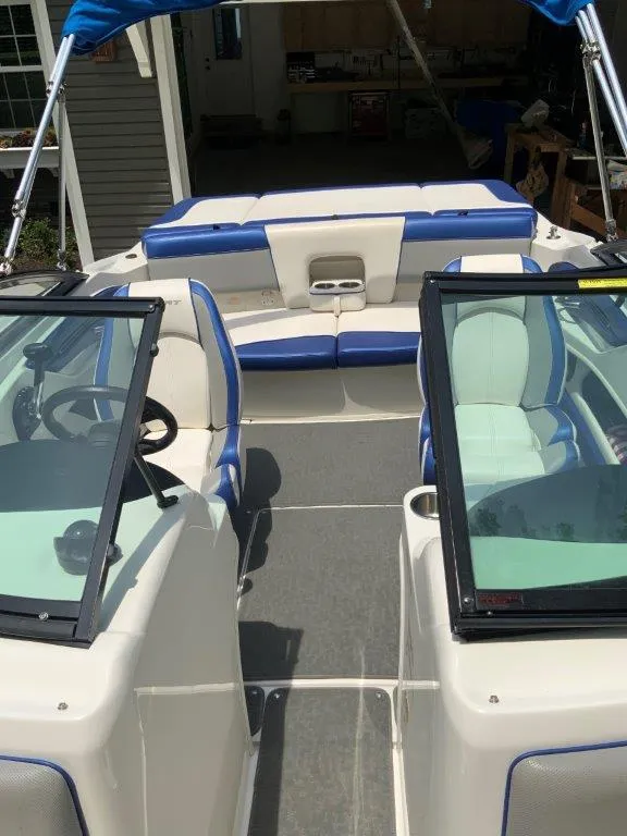 Slide: The Image of 2012 Sea Ray 205 Sport boat interior with blue and white seating. - 8