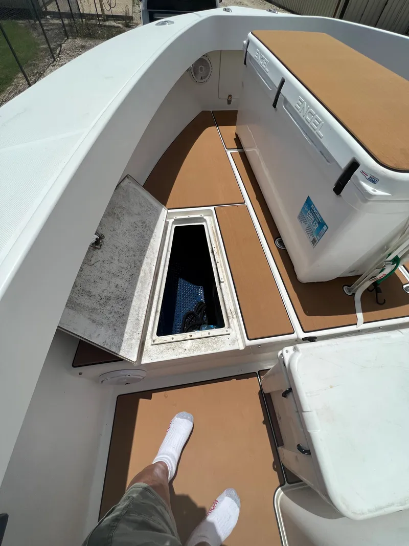 Slide: The Image of 2012 Ocean Master 336 CC boat deck with storage compartments and seating area. - 10