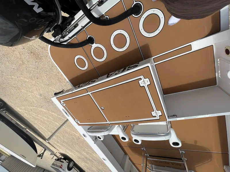 Slide: The Image of 2012 Ocean Master 336 CC boat deck with storage compartments and rod holders. - 13