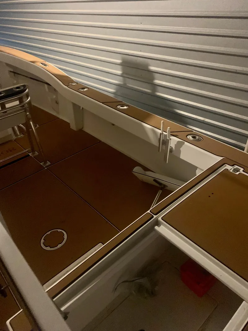 Slide: The Image of 2012 Ocean Master 336 CC boat interior with wooden deck and storage compartments. - 17