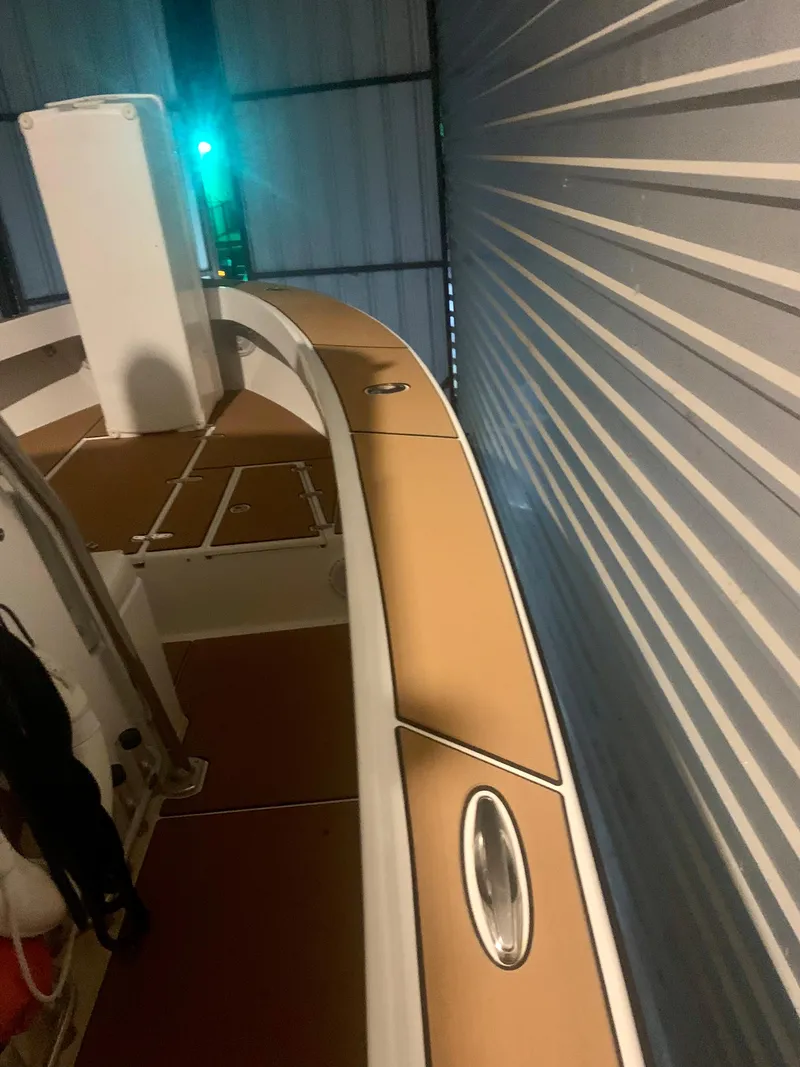 Slide: The Image of 2012 Ocean Master 336 CC boat in storage, featuring sleek deck design and metallic accents. - 18