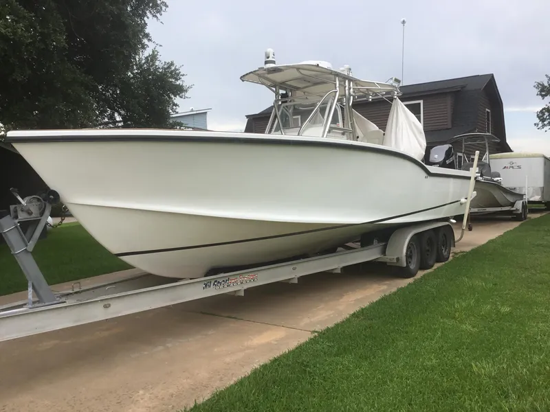 Slide: The Image of 2012 Ocean Master 336 CC boat on trailer, parked on driveway. - 22