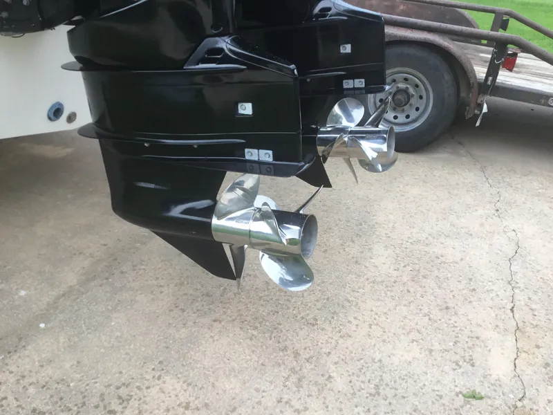 Slide: The Image of Twin propellers on a 2012 Ocean Master 336 CC boat, parked on a trailer. - 24