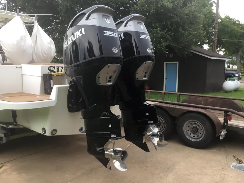 Slide: The Image of Twin Suzuki 350 outboard motors on a 2012 Ocean Master 336 CC boat. - 25