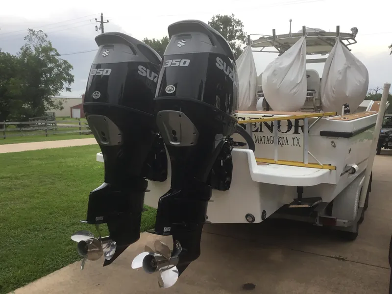 Slide: The Image of Twin Suzuki 350 outboard engines on a 2012 Ocean Master 336 CC boat. - 26