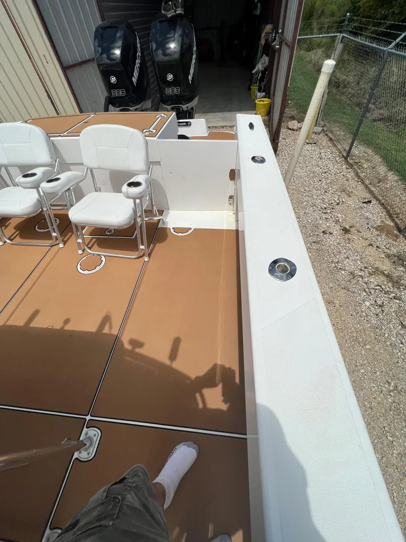 Slide: The Image of 2012 Ocean Master 336 CC boat deck with seating and dual engines in storage. - 6