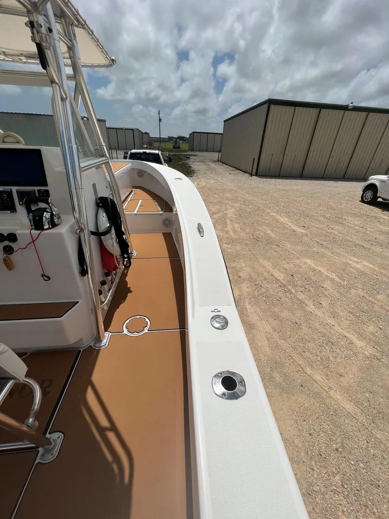 Slide: The Image of 2012 Ocean Master 336 CC boat docked on a sunny day, showcasing deck and control panel. - 7