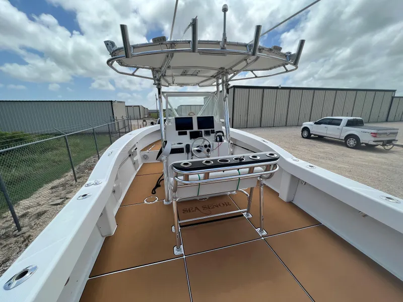 Slide: The Image of 2012 Ocean Master 336 CC boat with center console and fishing rod holders. - 9