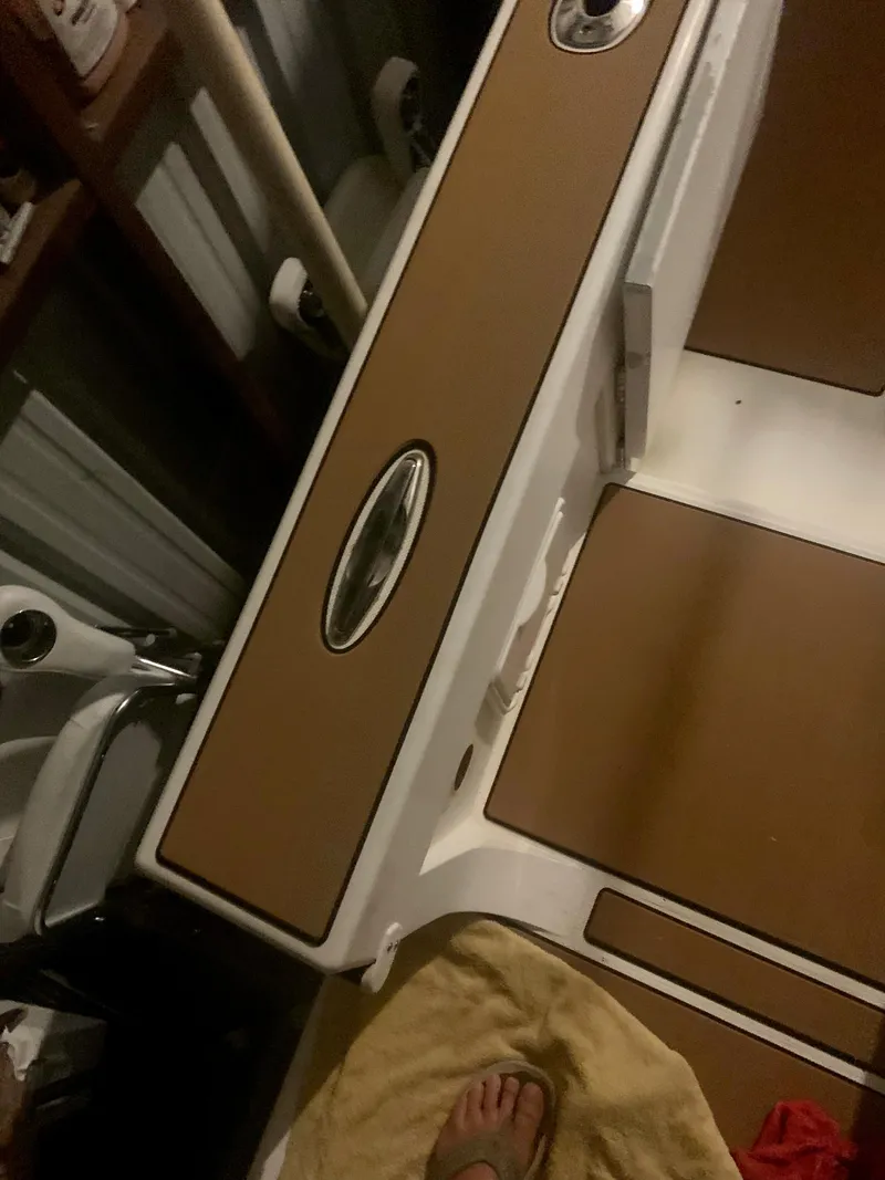 Slide: The Image of 2012 Ocean Master 336 CC boat interior with brown and white design elements. - 19
