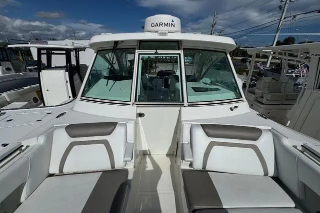 Slide: The Image of 2019 World Cat 320 DC boat with Garmin navigation, featuring spacious seating and modern design. - 17