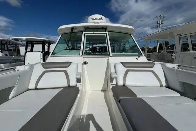 Slide: The Image of 2019 World Cat 320 DC boat interior with seating and Garmin equipment. - 19