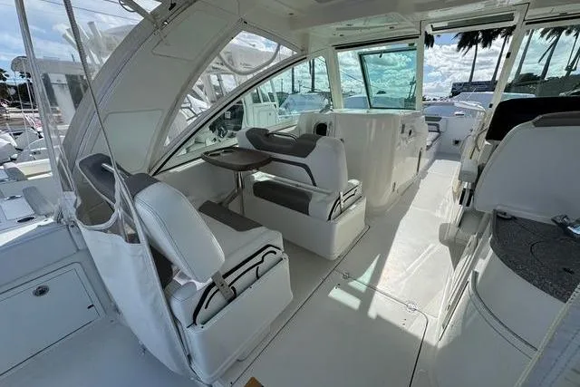 Slide: The Image of 2019 World Cat 320 DC boat interior with seating and table, showcasing modern design. - 20