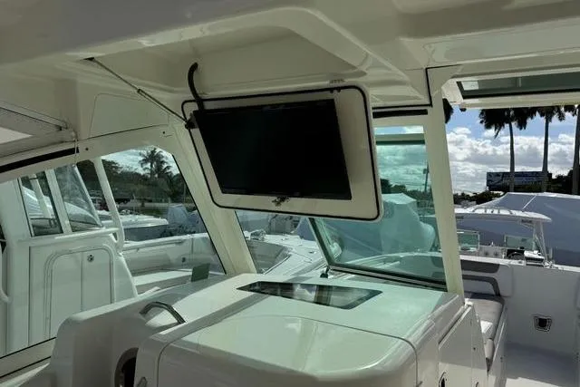 Slide: The Image of 2019 World Cat 320 DC boat interior with mounted TV and sleek design. - 29