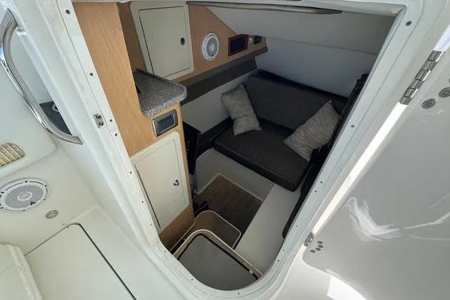 Slide: The Image of 2019 World Cat 320 DC cabin interior with seating and storage. - 30