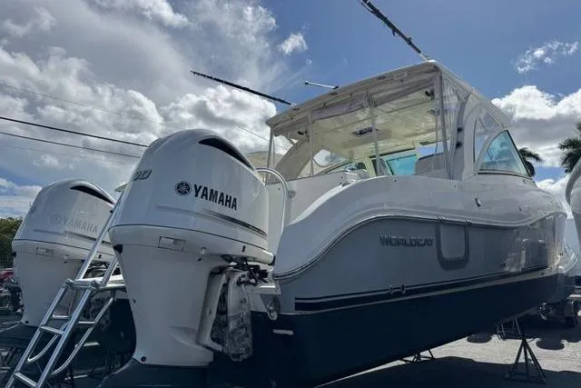 Slide: The Image of 2019 World Cat 320 DC boat with Yamaha engines, docked under a cloudy sky. - 31