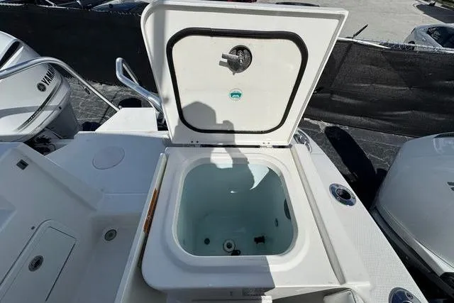 Slide: The Image of Open storage compartment on 2019 World Cat 320 DC boat deck. - 32