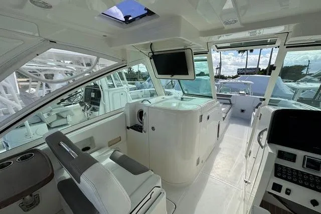 Slide: The Image of 2019 World Cat 320 DC boat interior with modern helm and seating. - 35