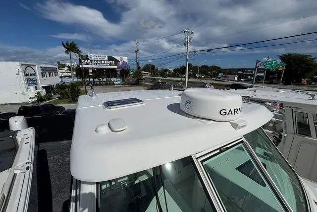 Slide: The Image of 2019 World Cat 320 DC boat with Garmin radar, parked near a street. - 36