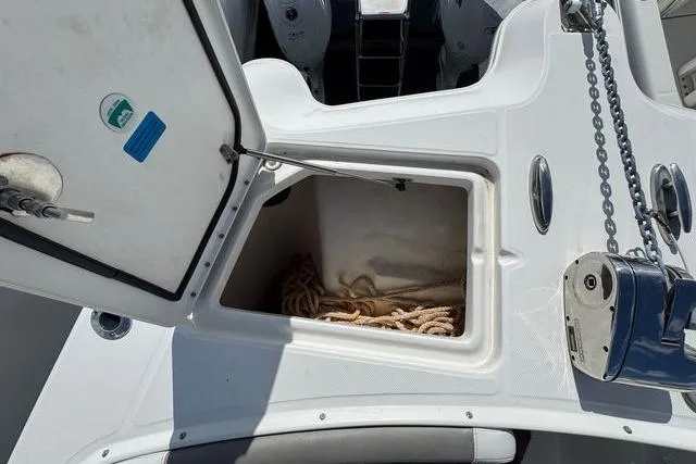 Slide: The Image of Open storage compartment on 2019 World Cat 320 DC boat with rope inside. - 41