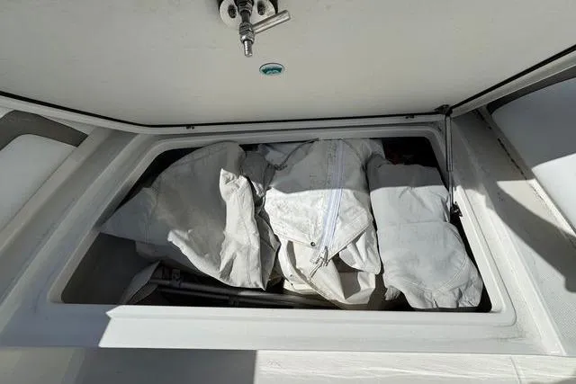 Slide: The Image of Storage compartment on a 2019 World Cat 320 DC boat with canvas covers inside. - 43