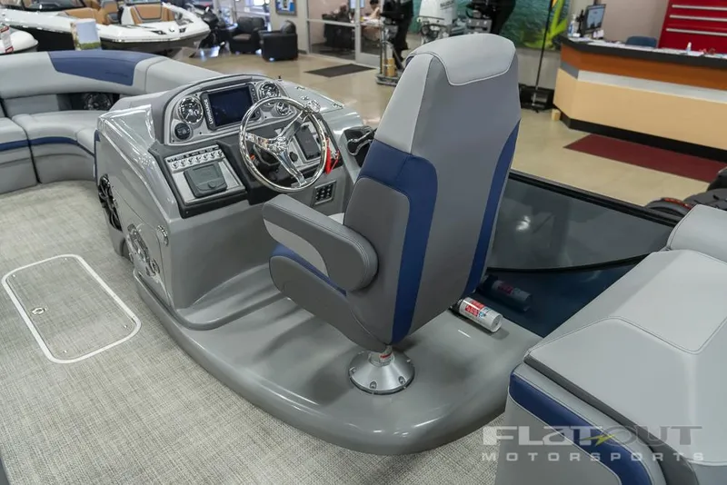 Slide: The Image of 2022 South Bay 525 RS 3.0 Arch 250HP boat interior with captain's chair and control panel. - 12