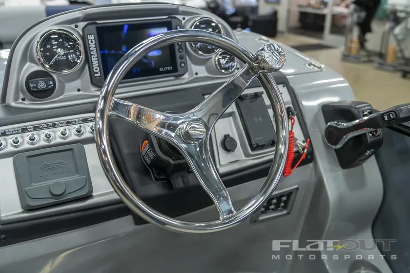 Slide: The Image of 2022 South Bay 525 RS 3.0 Arch 250HP boat dashboard with steering wheel and controls. - 13