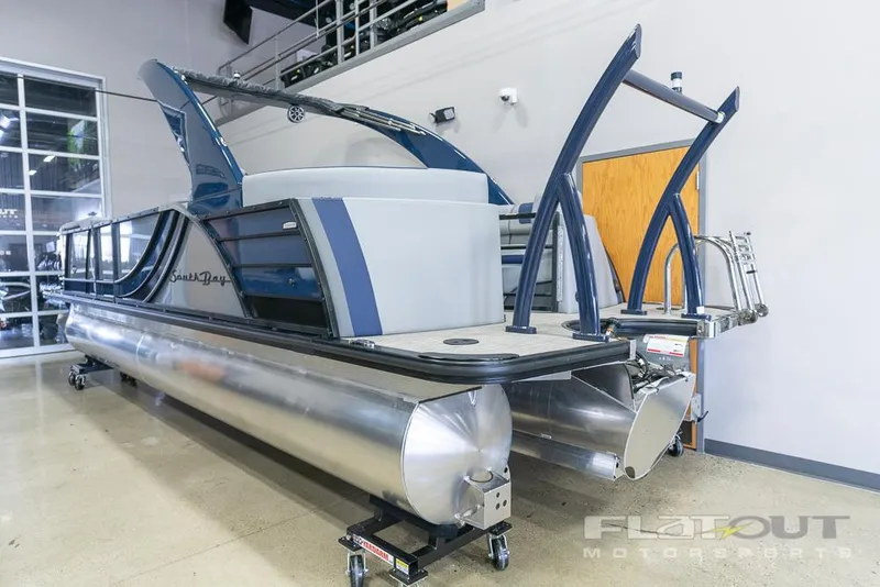 Slide: The Image of 2022 South Bay 525 RS 3.0 Arch 250HP pontoon boat displayed indoors. - 5