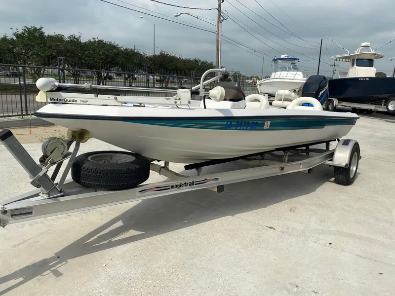 Slide: The Image of 1996 Champion 186 SC boat on a trailer with MotorGuide trolling motor. - 4