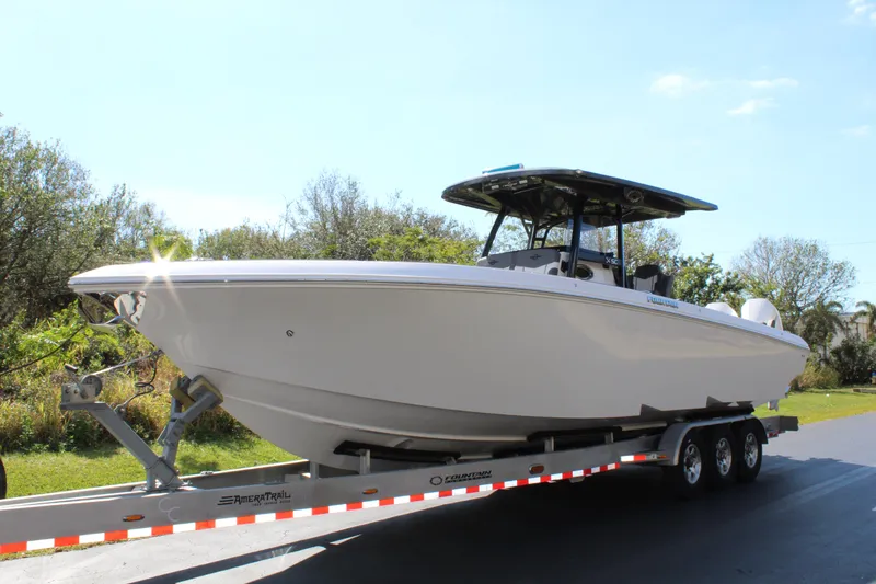 Slide: The Image of 2023 Fountain 34 SC boat on a trailer, parked outdoors. - 0