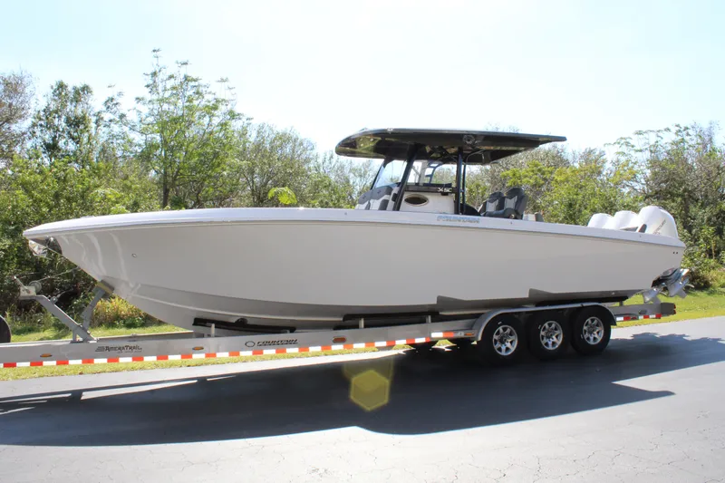 Slide: The Image of 2023 Fountain 34 SC boat on a trailer, parked outdoors. - 1