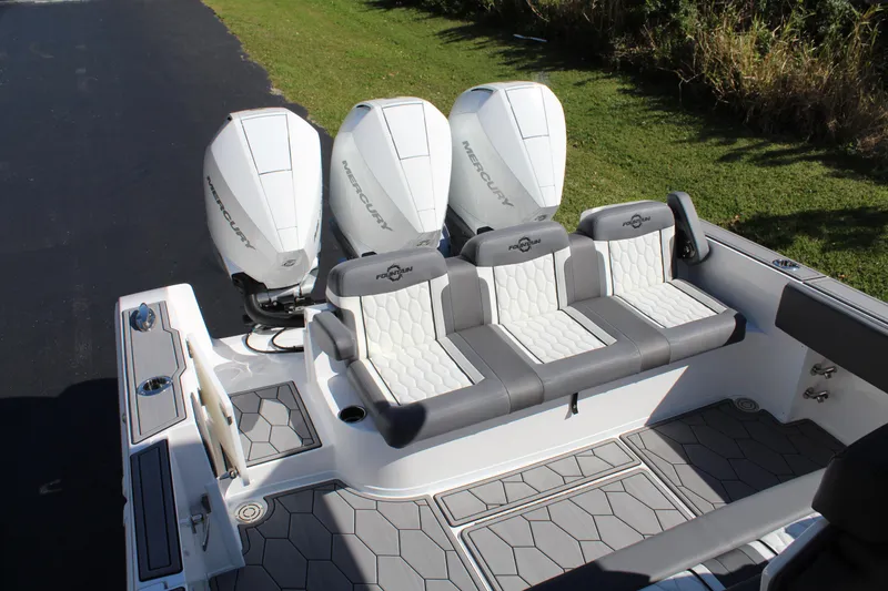 Slide: The Image of 2023 Fountain 34 SC boat with triple outboard engines and stylish seating. - 11