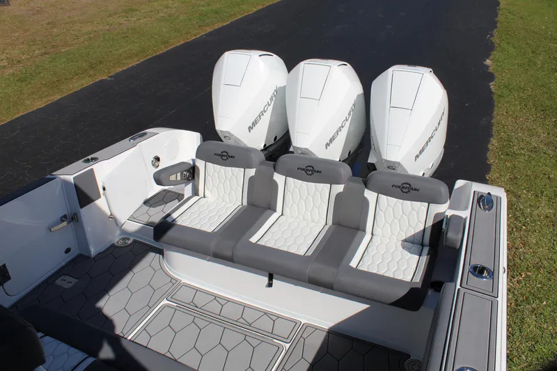 Slide: The Image of 2023 Fountain 34 SC boat with triple Mercury engines and stylish seating. - 15