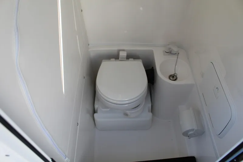 Slide: The Image of 2023 Fountain 34 SC boat bathroom interior with toilet and sink. - 19