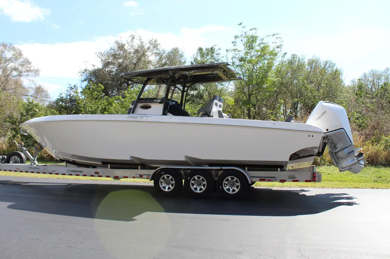 Slide: The Image of 2023 Fountain 34 SC boat on trailer, side view, outdoors. - 2