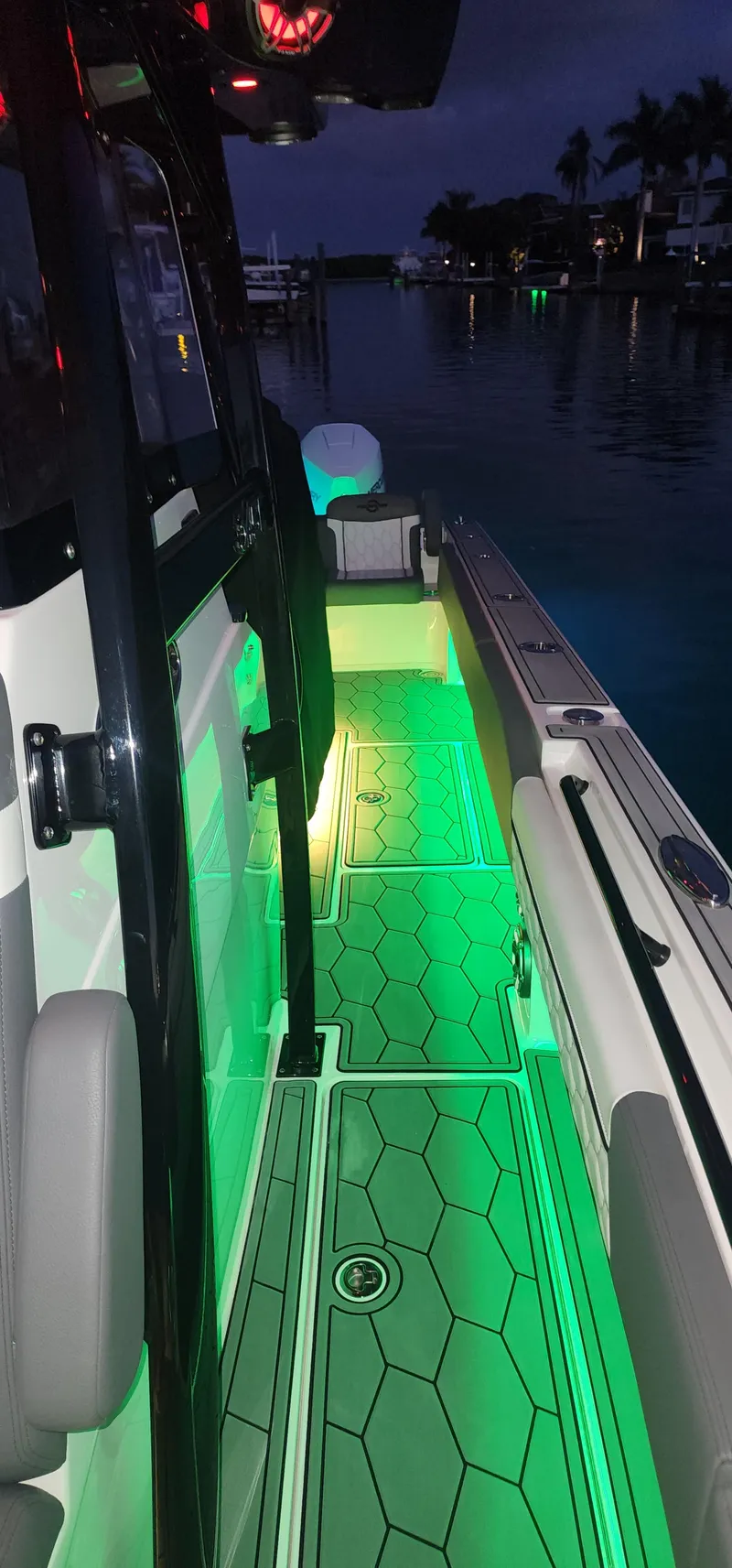 Slide: The Image of 2023 Fountain 34 SC boat with green LED deck lighting at night. - 22