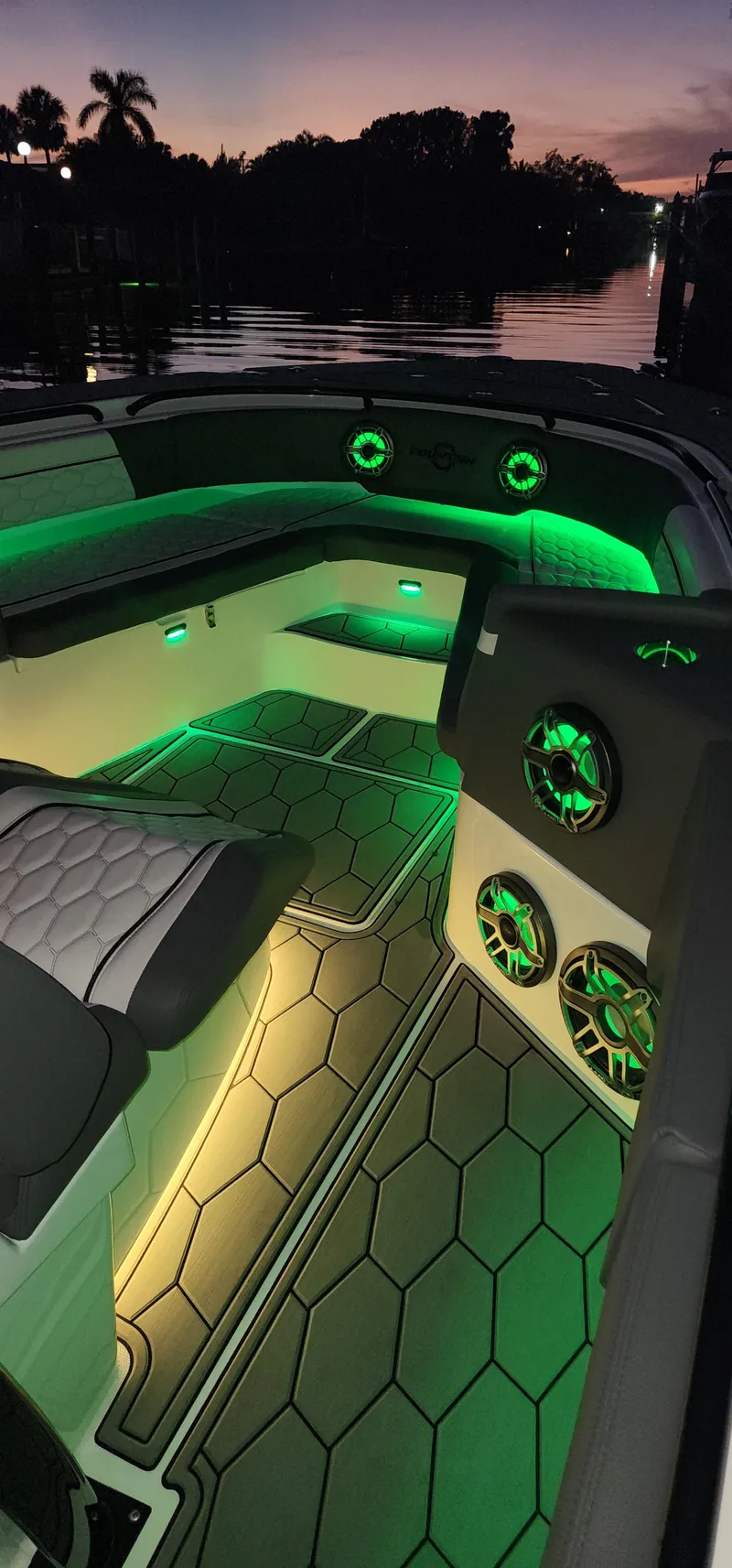 Slide: The Image of 2023 Fountain 34 SC boat interior with green LED lighting at sunset. - 25