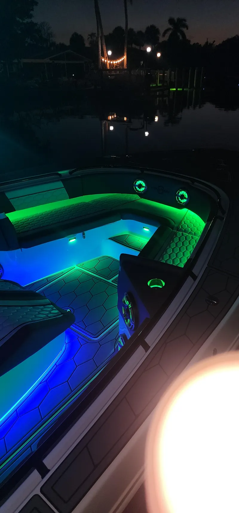 Slide: The Image of 2023 Fountain 34 SC boat with vibrant LED lighting at night. - 26