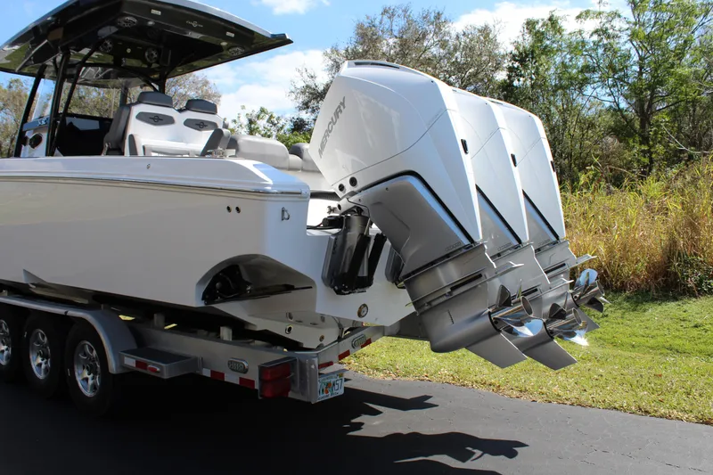 Slide: The Image of 2023 Fountain 34 SC boat on trailer with powerful outboard engines. - 4
