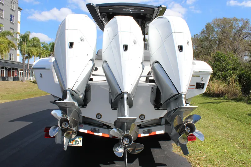 Slide: The Image of 2023 Fountain 34 SC boat with triple outboard engines on a sunny day. - 5