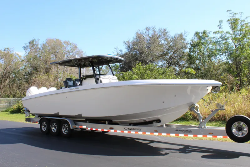 Slide: The Image of 2023 Fountain 34 SC boat on trailer, parked outdoors. - 6