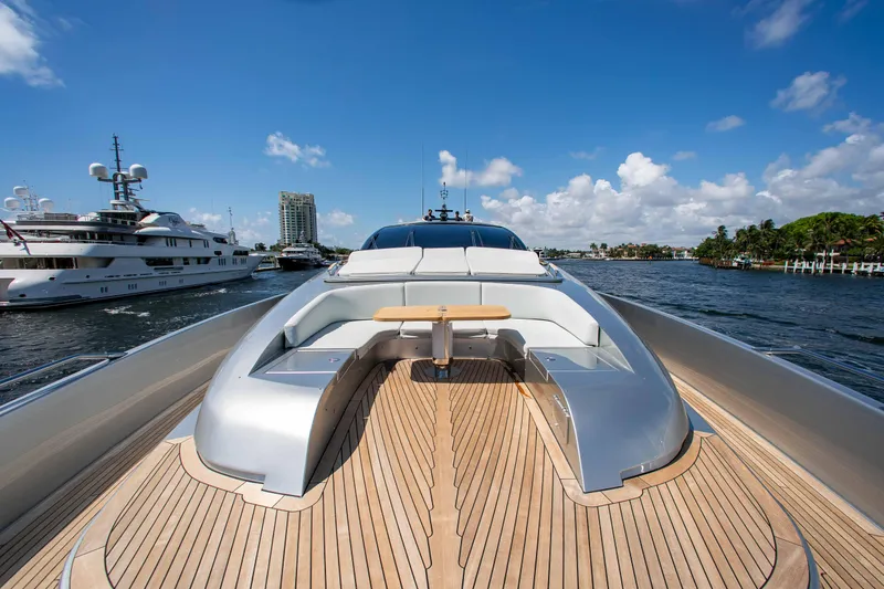 Slide: The Image of 2014 Riva Mythos Motoryacht with sleek deck design and luxurious seating, docked in a marina. - 28