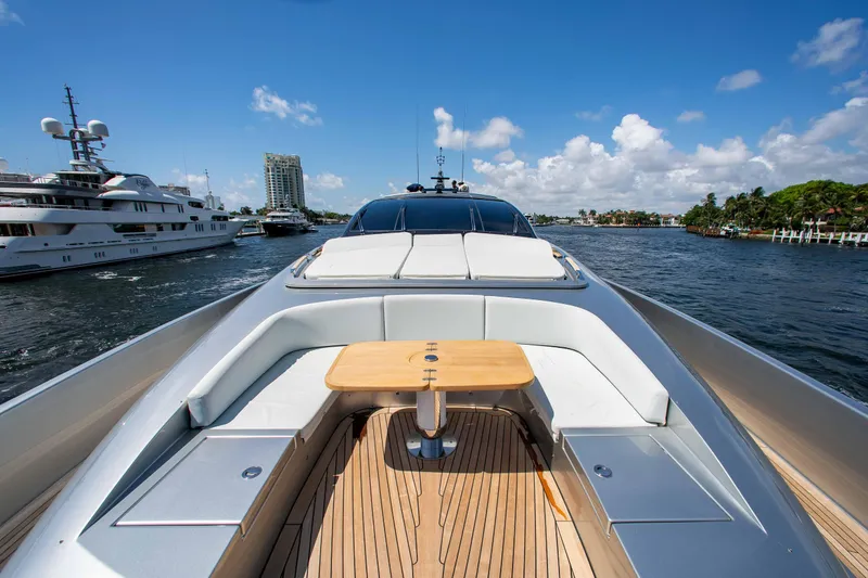 Slide: The Image of Luxurious 2014 Riva Mythos Motoryacht with elegant deck seating and scenic waterfront view. - 29