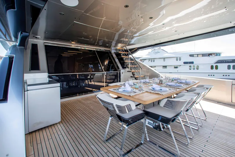 Slide: The Image of Luxurious 2014 Riva Mythos Motoryacht deck with elegant dining setup and modern design. - 32