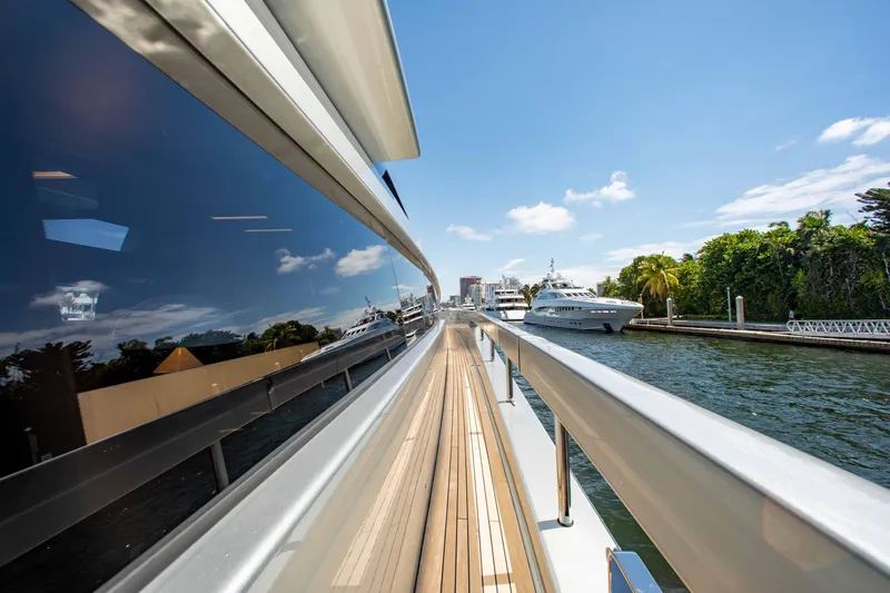 Slide: The Image of 2014 Riva Mythos Motoryacht deck view, reflecting water and sky, docked in a marina. - 40