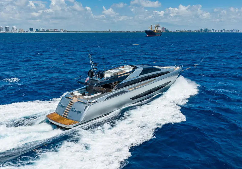 Slide: The Image of Luxurious 2014 Riva Mythos Motoryacht cruising on open blue sea under clear skies. - 6